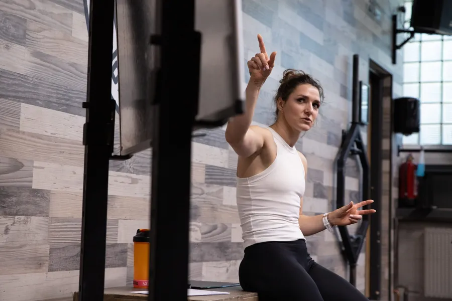 MDDr. Kateřina Lízlerová u tabule s grafem hormonálního cyklu v CrossFit centru Los Podolos